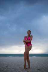 Fototapeta na wymiar Fitness model on the beach at storm