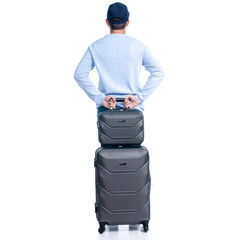Man in jeans with travel suitcase standing on white background isolation, back view