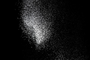White powder splash isolated on black background. Flour sifting on a black background. Explosive...