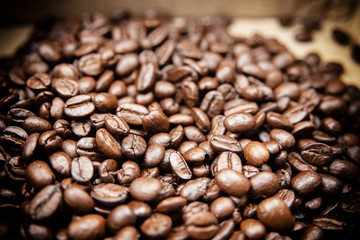 Closeup group of coffee bean on background,blurry light around