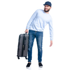 Man in jeans holding travel suitcase standing on white background isolation