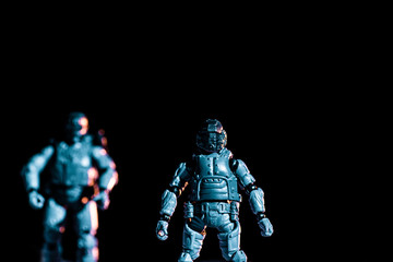 selective focus of toy plastic soldiers isolated on black