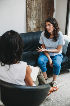 Psychotherapy session, woman talking to his psychologist in the studio
