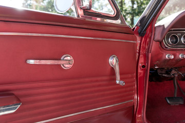 Old retro car door with red leather padding inside