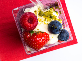 fresh summer dessert with berries, whipped cream, and nuts