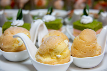  delicious vanilla eclair on white spoon.