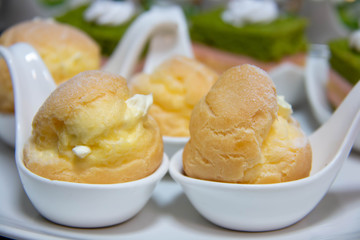  delicious vanilla eclair on white spoon.
