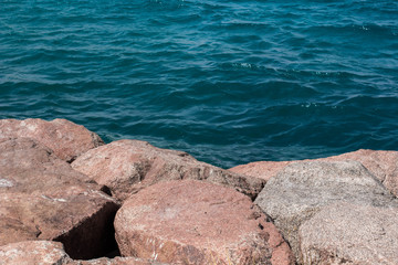 natural local scenic background landscape of stone waterfront shoreline and blue water 