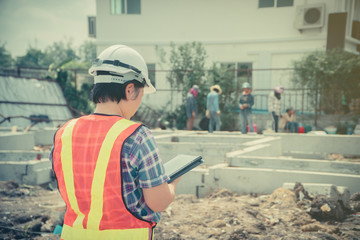 Asian women engineering holds a tablet for use in the inspection of construction sites for accuracy and in accordance with the plan. Concept of Equal rights between men and women