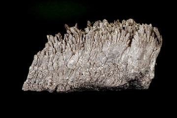 Macro of a stone Stibnite mineral on a black background