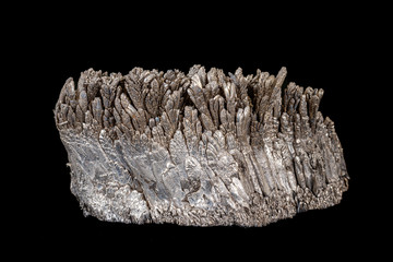 Macro of a stone Stibnite mineral on a black background