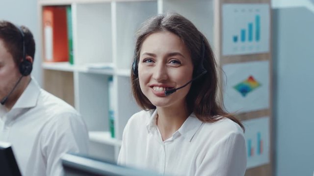 Portrait of happy smiling female customer support phone operator at workplace. Profession and business concept. Feeling good, successful lifestyle, workaholic, working hard. Close up view