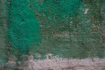 Texture of concrete wall and foundation close-up with falling off paint