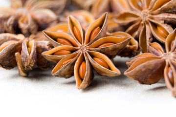 Chinese Star anise spice fruits and seeds for ingredient cooking makes food fine fragrance and essential oil on a light background.
