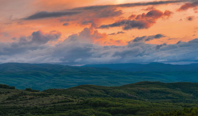 Colorful Spring Sunset over mountains and dramatic sky