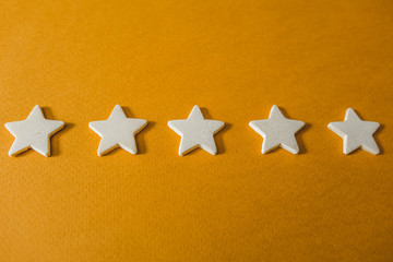 five white stars on an orange background