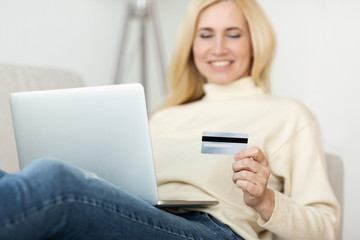 Middle-Aged Woman Using Credit Card For Paying