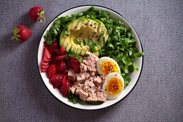 Tuna strawberry avocado egg and spinach salad in bowl - healthy food