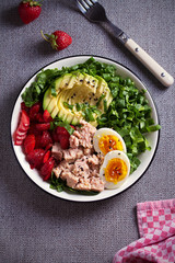 Tuna strawberry avocado egg and spinach salad in bowl - healthy food