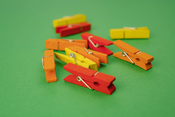 plastic clothespins on a green background.