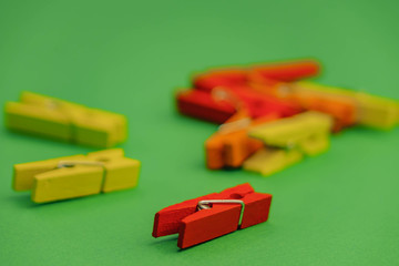 Red plastic clothespins on a white background.