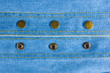 clothing items blue stonewashed faded jeans cotton fabric texture with seams, clasps, buttons and...