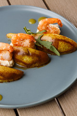 Grilled tiger shrimps with honey rear and cream cheese. Grilled seafood. On wooden background.