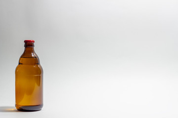 Beer bottle with a red cork on a gray background. Design. Minimalism. Creative idea. Mock-up.