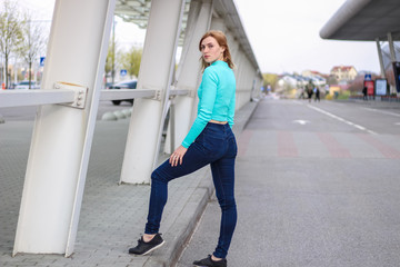 Obraz premium The girl is blonde in a blue croptop. Street clothing. Sport. Advertising. Fashion and style. Copyspace. Mockup