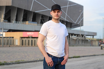 Fototapeta premium Charismatic man in a white T-shirt. Advertising Banner Fashion and Style. Mockup.Copyspace