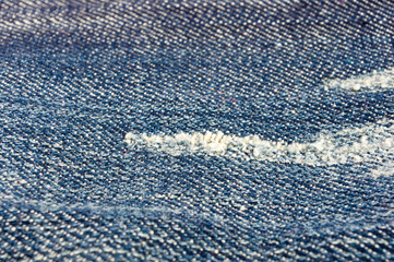 clothing items blue stonewashed faded jeans cotton fabric texture with seams, clasps, buttons and...