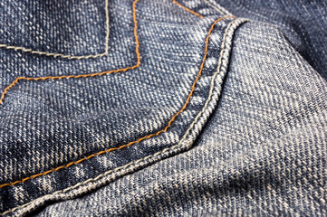 clothing items blue stonewashed faded jeans cotton fabric texture with seams, clasps, buttons and...