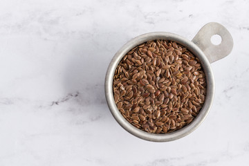 Brown Flaxseeds in a Measuring Cup