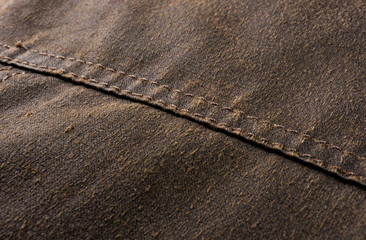 clothing items stonewashed cotton fabric texture with seams, clasps, buttons and rivets, macro