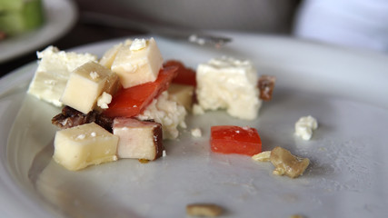 Eating a fresh mixed salad with tomato, cheese, ham, mushrooms, cinematic dof close up