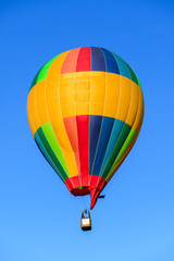 Fototapeta premium multi-colored balloon in the blue sky aeronautics competition, the first air transport
