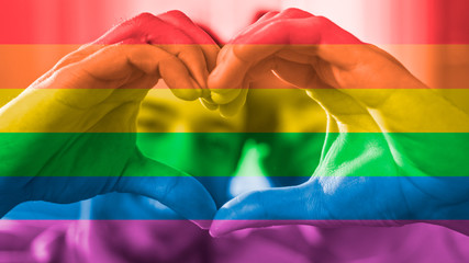 Cute Smiling Male Loving Couple at Home Making a Heart Symbol with Their Hands. Room Has Modern...