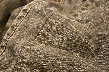 clothing items stonewashed cotton fabric texture with seams, clasps, buttons and rivets, macro