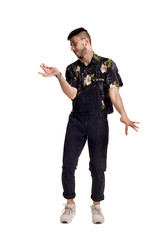 Full-length portrait of a funny guy dancing in studio isolated on white background.