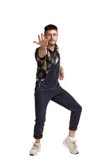 Full-length portrait of a funny guy dancing in studio isolated on white background.