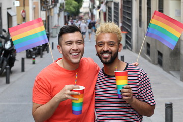 Festive gay couple celebrating outdoors