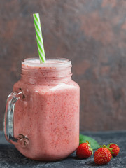 Strawberry smoothie with banana or strawberry milkshake in a glass jar with copyspace