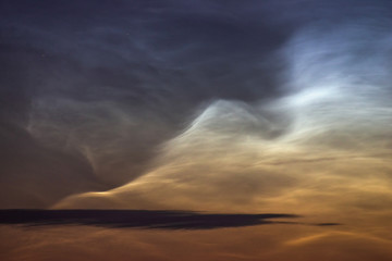 Noctilucent clouds closeup summer night.