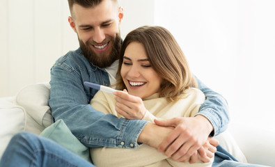 I'm Pregnant! Happy Couple Checking Pregnancy Test © Prostock-studio