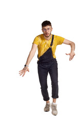 Full-length portrait of a funny guy dancing in studio isolated on white background.