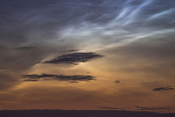 Noctilucent clouds closeup summer night.