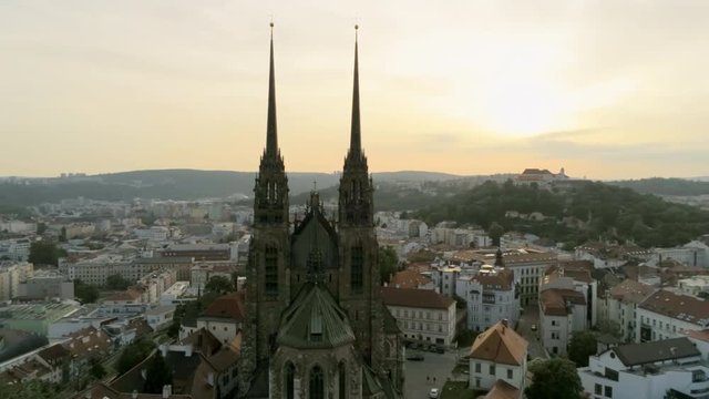 Brno Cityscape with Landmarks. Cathedral of St. Peter And St. Paul. Aerial View of Old Town with Medieval Gothic Church on Petrov Hill at Sunset. Europe, Czech Republic. 4K Pan Quadcopter Shot