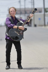 Fototapeta na wymiar Street musician with guitar and big personality