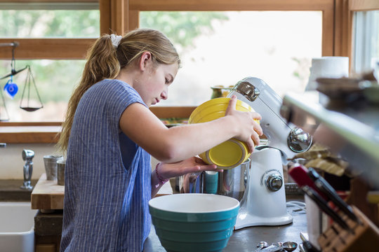 13 year old girl baking in the kitchen