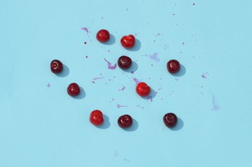 Red ripe cherries  on blue background, fruit pattern,photo
